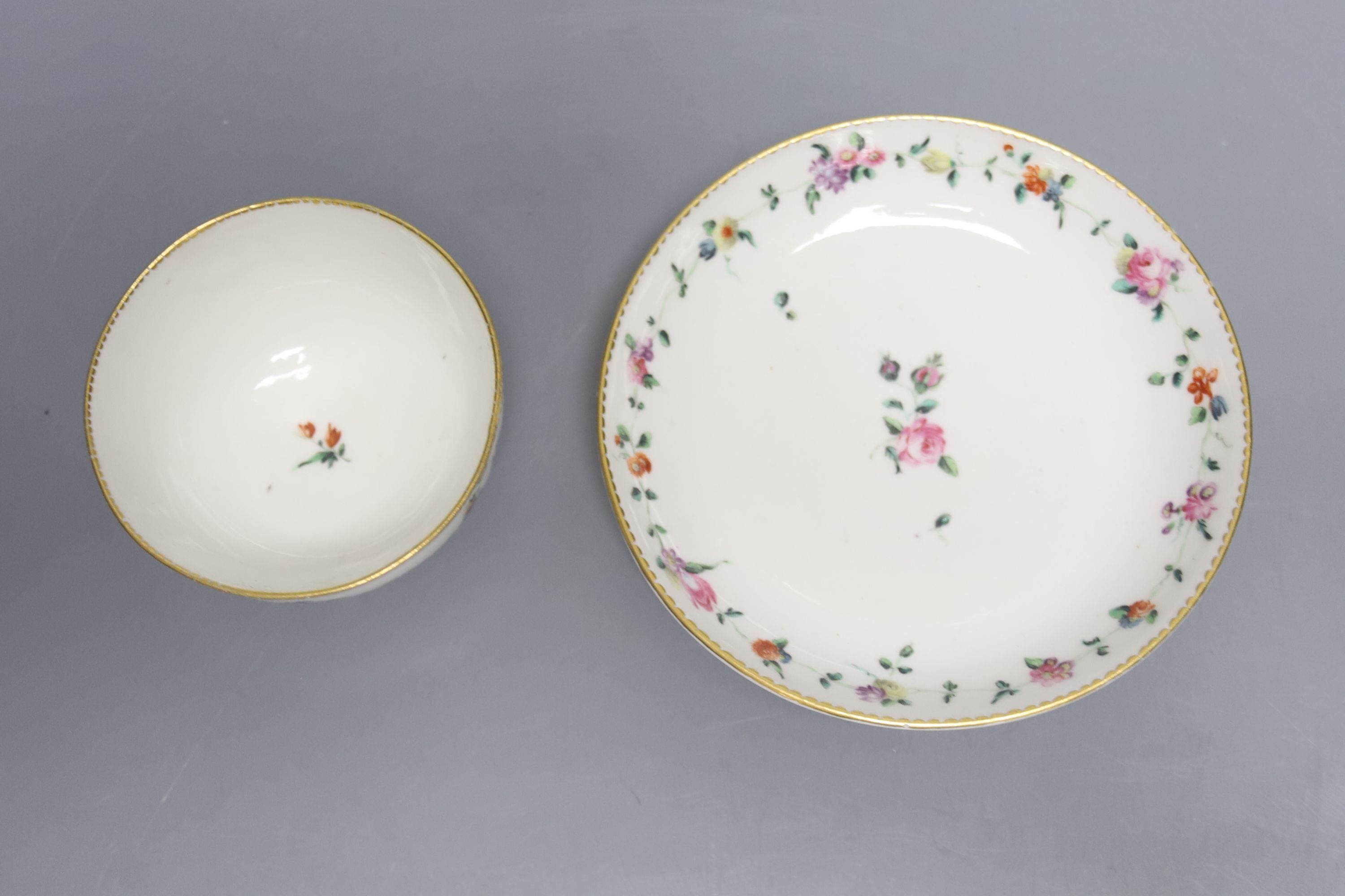 A Chelsea Derby teabowl and saucer painted with chains of flowers, anchor 'D' in gold, label for Alasdair Morrison c. 1775
